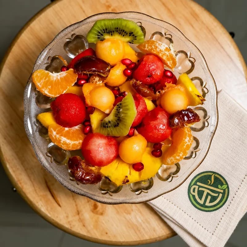 Fresh fruit breakfast bowl with T VANAMM branding